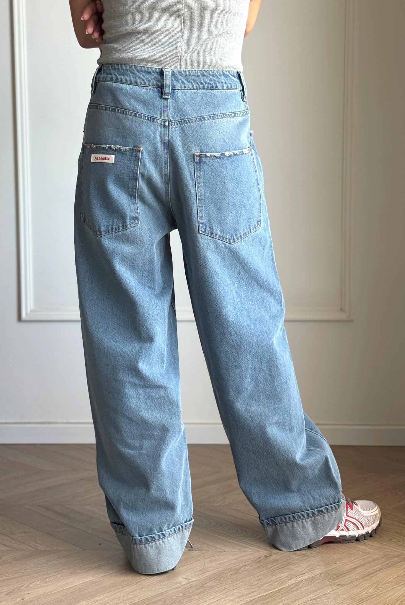Assemble unisex denim twisted wide-leg jeans in light blue wash