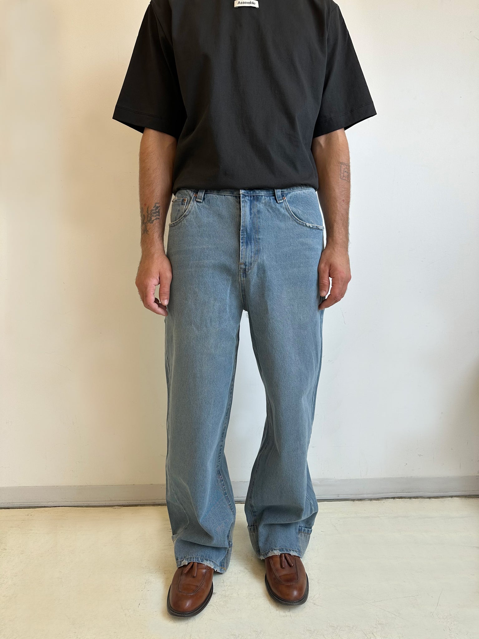 Assemble unisex denim twisted wide-leg jeans in light blue wash