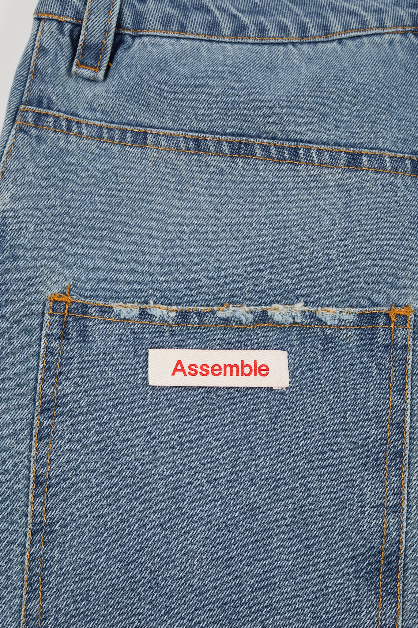 Assemble unisex denim twisted wide-leg jeans in light blue wash