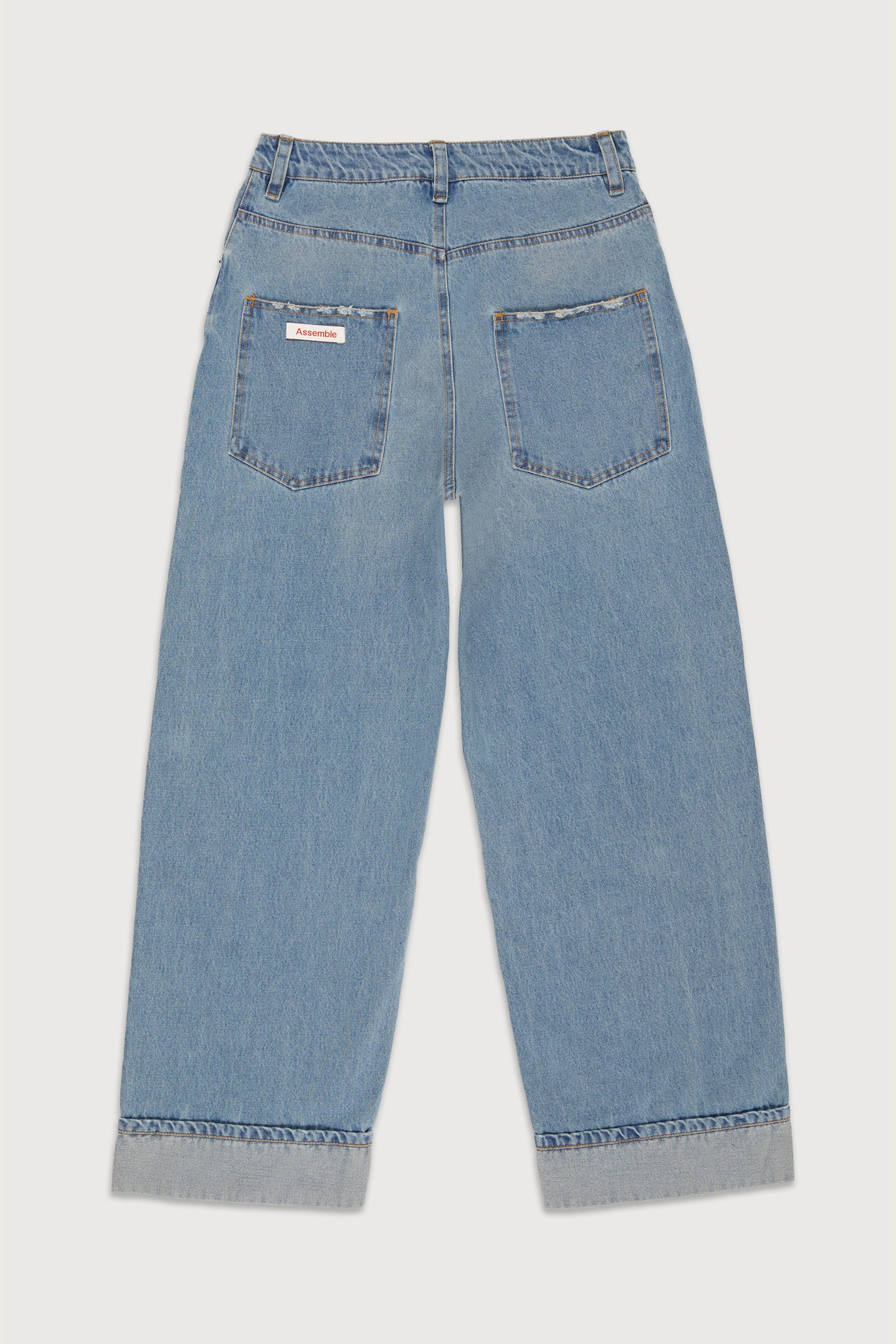 Assemble unisex denim twisted wide-leg jeans in light blue wash